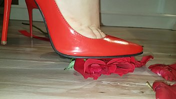 Red high heels crushing a rose